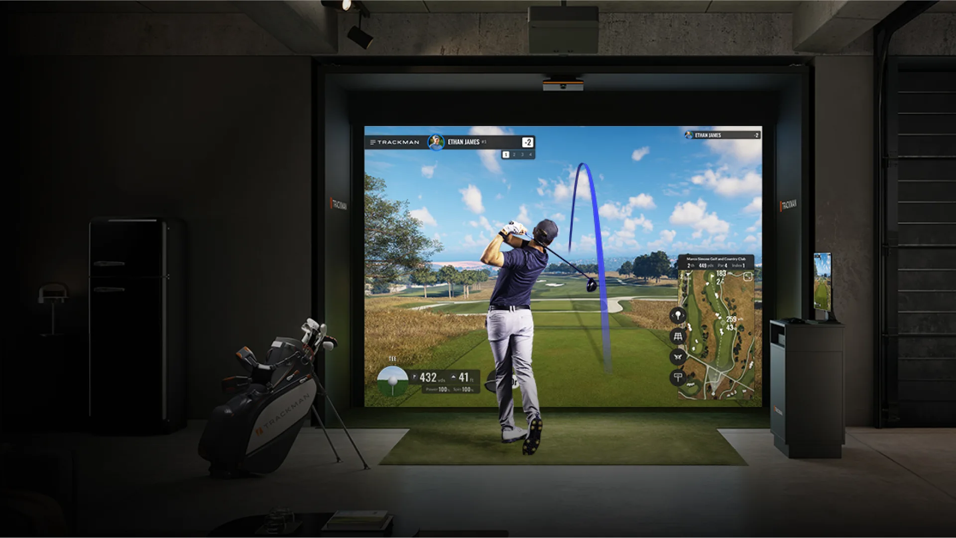 Illustrative Trackman simulator scene with a golfer and a ceiling-mounted iO unit